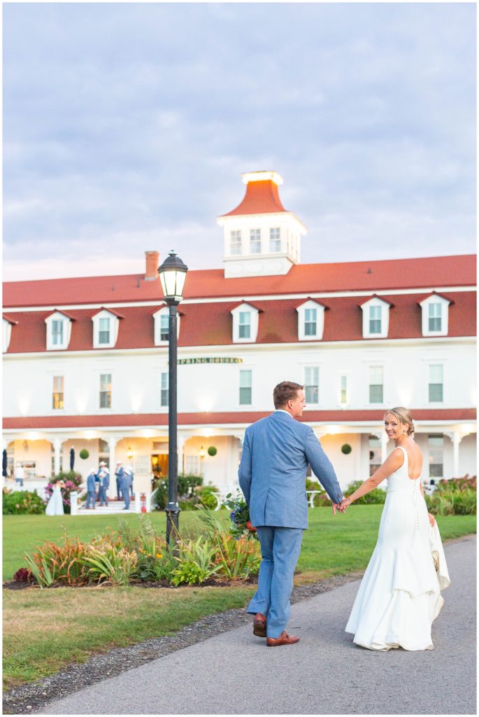 Bride and Groom walk to their tented wedding reception at Spring House venue in Rhode Island. 