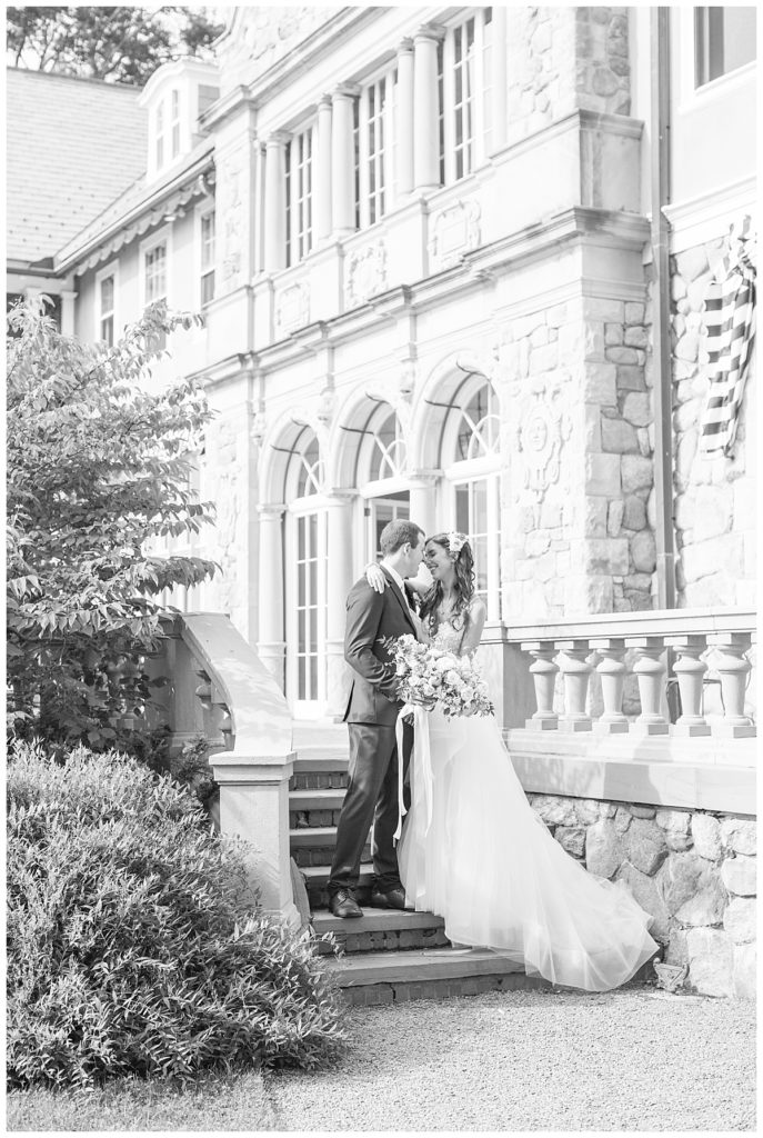 Bride and Groom pose on the staircase of Blithewold Mansion on their wedding day in Bristol, Rhode Island. 