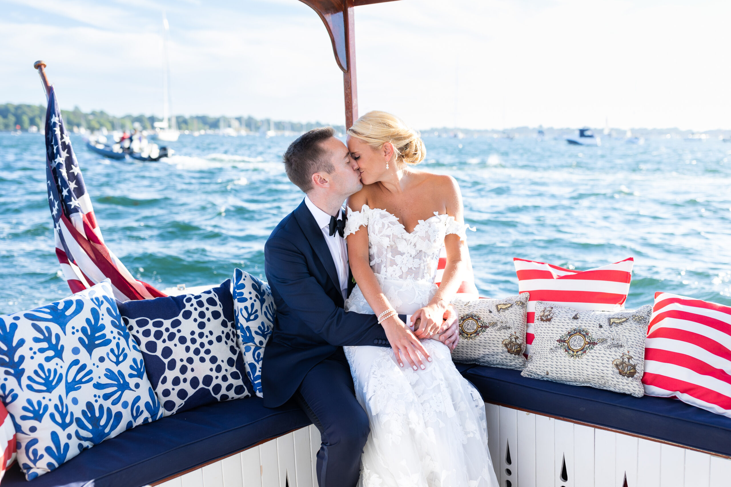 Bride and Groom kiss on boat sailing on Newport, RI Harbor