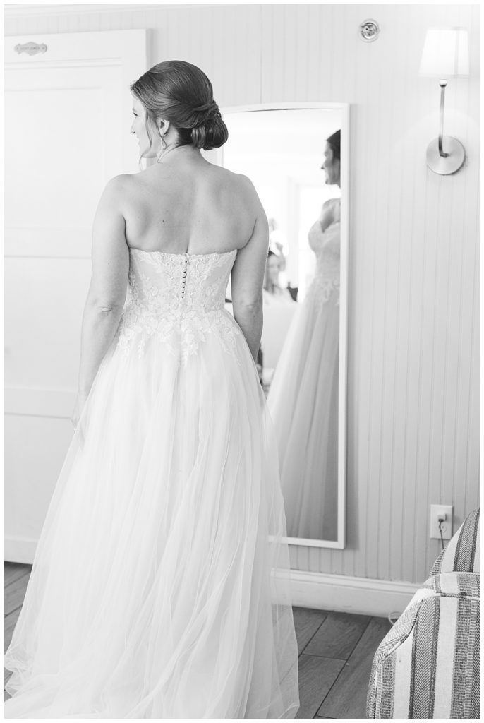 A bride looks in the mirror at Spring House.