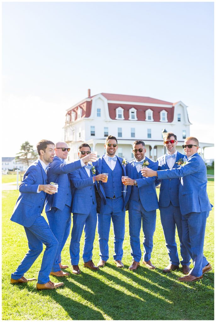 Groom & groomsmen pose with cocktails on the front lawn of the Spring House. 