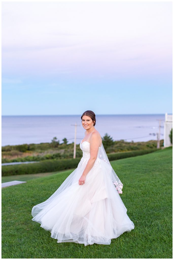 A bridal portrait in front of a purple sunset at spring house. 