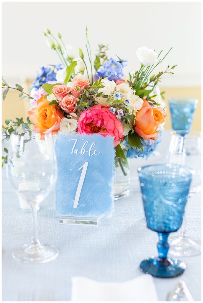 wedding tablescape featuring vintage blue goblets and watercolor table numbers