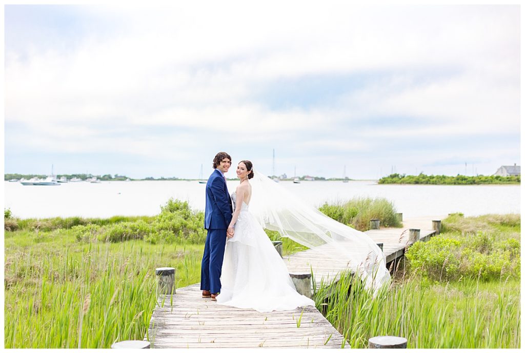 bride and groom on Block Island dock with bay in background
