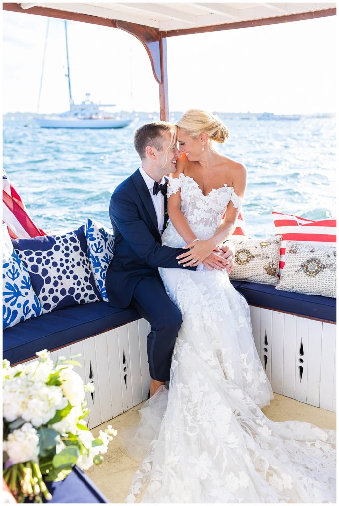 bride and groom pose on nautical themed boat after wedding ceremony