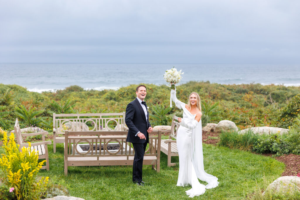 Bride and groom cheer in the herb garden at the Ocean house overlooking the beach