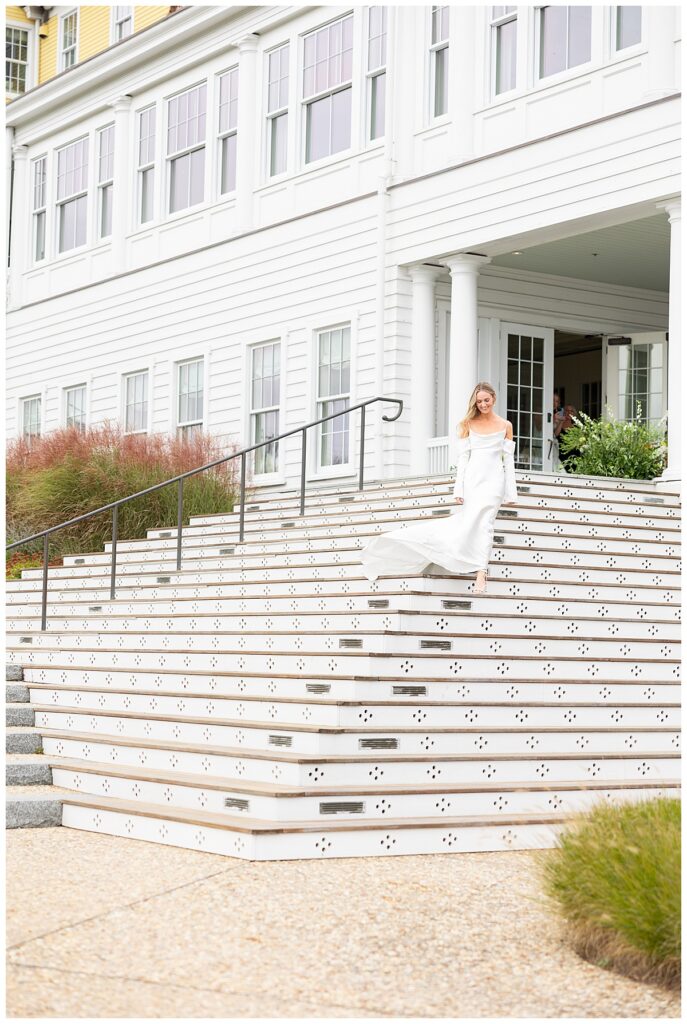 Bride walking down staircase at Ocean House