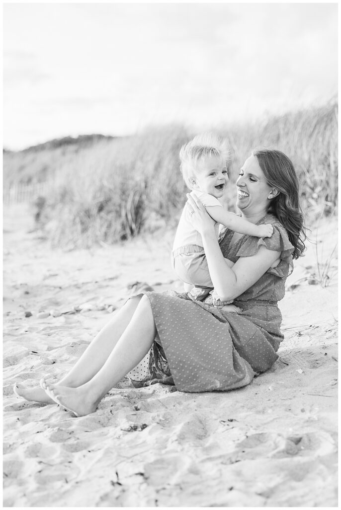 Baby and mom sit in sand on Second beach in Newport, RI