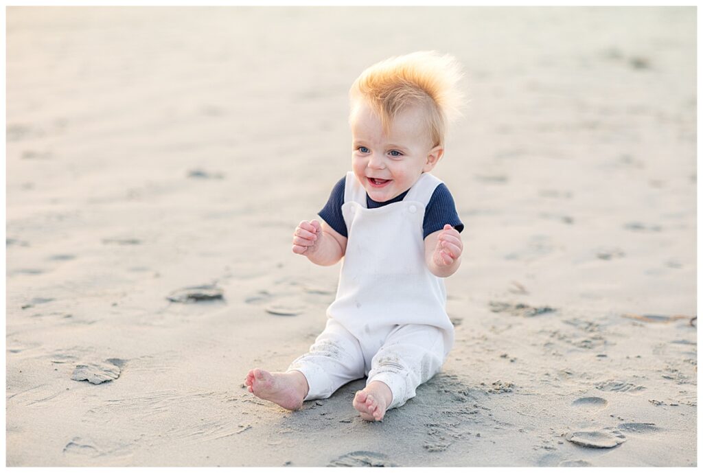 Portrait of baby sitting in the sand during family photos in Newport, RI