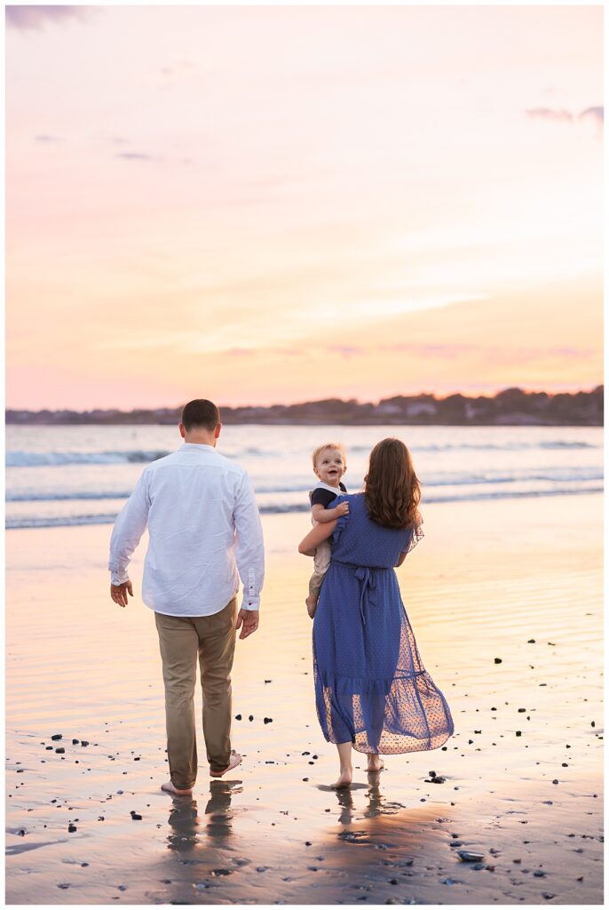 Family walks the beach at sunset in Newport RI
